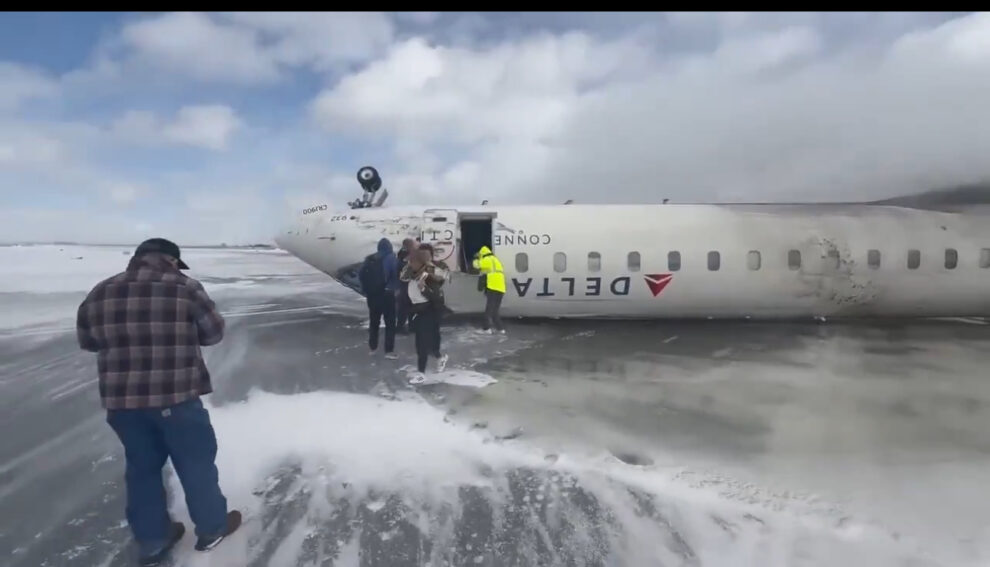 Delta plane comes to rest upside down after flipping over while landing